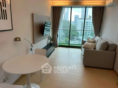 Modern living room with city view, featuring sleek furniture and large windows.