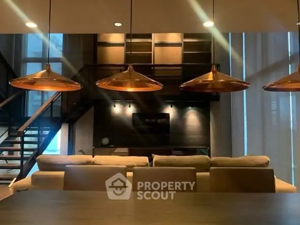 Luxurious modern living room with stylish lighting and open staircase