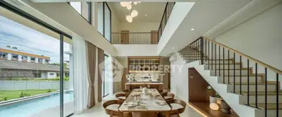 Luxurious open-plan living room with pool view and elegant dining area in modern home.