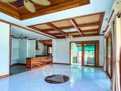 Spacious living room with wooden ceiling and open kitchen layout