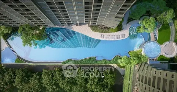 Stunning aerial view of luxury apartment complex with expansive pool and lush greenery.