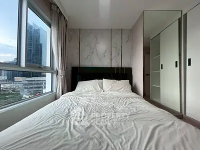 Modern bedroom with large windows and city view, featuring sleek design and ample natural light.