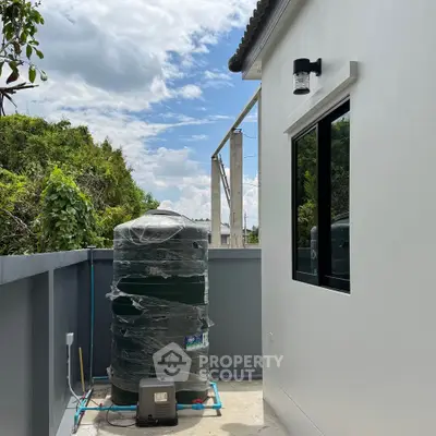 Modern exterior with water tank and clear sky view