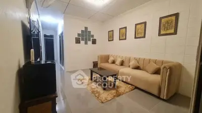Cozy living room with elegant sofa and wall art, perfect for relaxation.