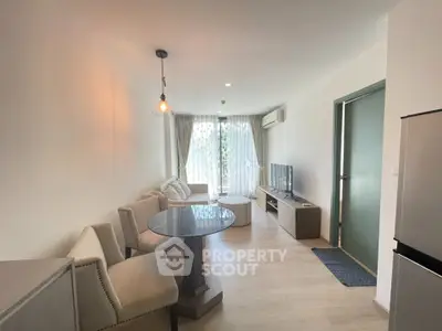 Modern living room with stylish furniture and natural light, perfect for relaxation and entertainment.