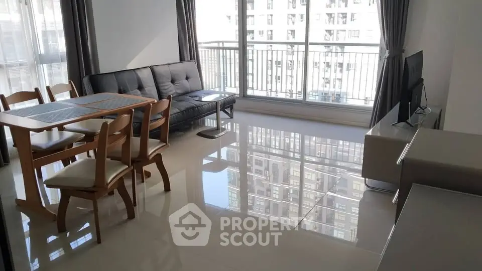 Spacious living room with modern furniture and large windows offering city views.