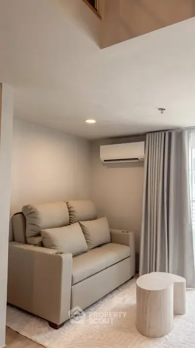 Cozy living room with modern sofa and air conditioning in a stylish apartment.