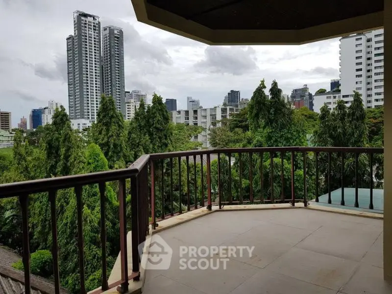 Spacious balcony with stunning cityscape and lush greenery views, perfect for relaxation and entertainment.