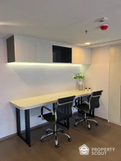 Modern study room with sleek desk and chairs, perfect for productivity.