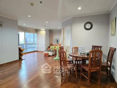 Spacious living room with wooden flooring and dining area in modern apartment