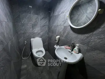 Modern bathroom with sleek gray tiles and contemporary fixtures