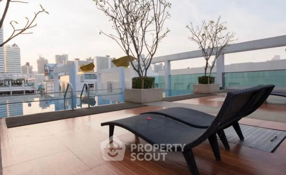 Luxurious rooftop pool area with city skyline views and stylish lounge chairs.