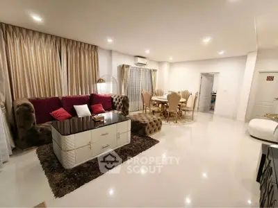 Luxurious open-plan living and dining area with elegant furnishings and modern decor.