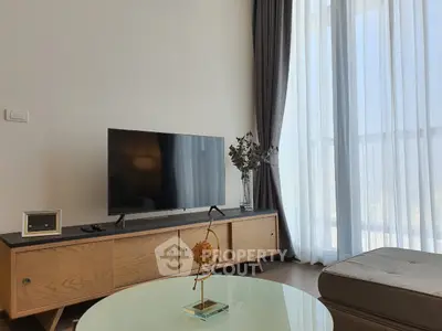 Modern living room with stylish decor and large window for natural light