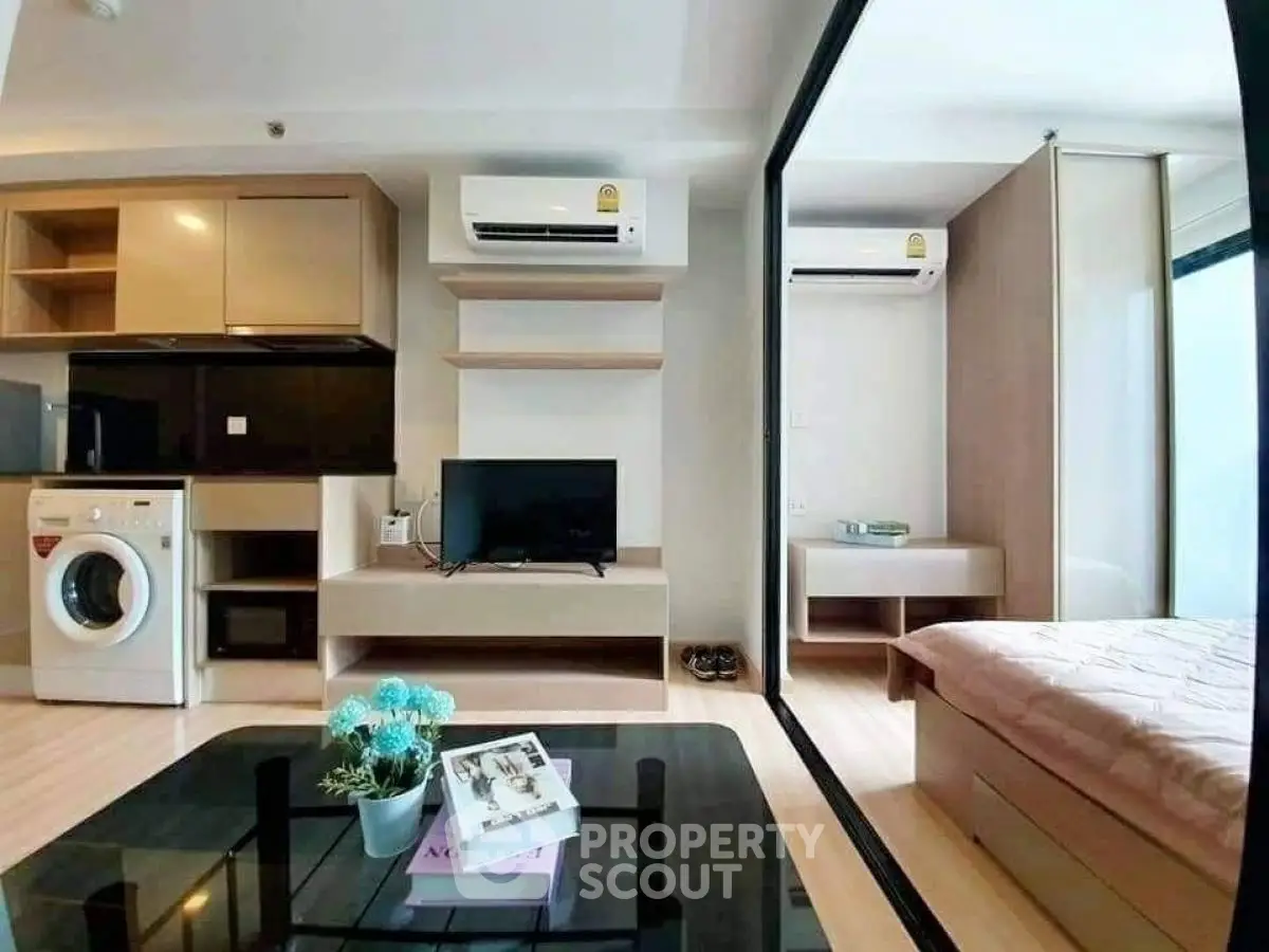 Modern studio apartment with open layout, featuring a cozy living area, compact kitchen, and stylish bedroom.