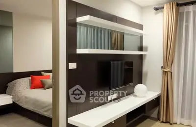 Modern bedroom with sleek TV setup and stylish decor