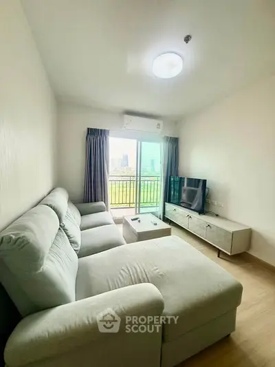 Modern living room with large sofa and city view balcony in a stylish apartment.