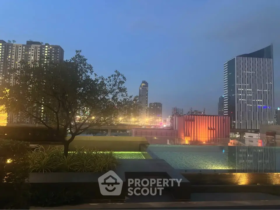 Stunning rooftop pool with city skyline view at dusk, perfect for urban living.