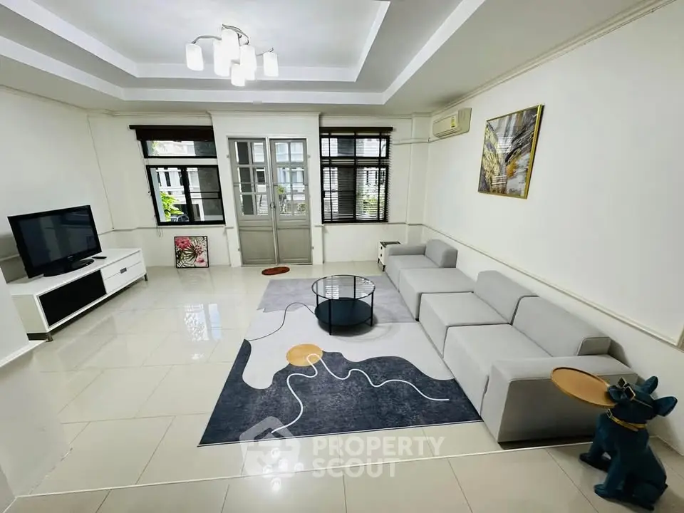 Modern living room with stylish decor and large windows