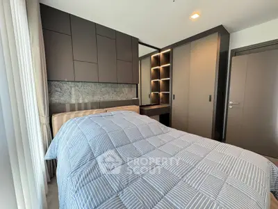 Modern bedroom with stylish cabinetry and cozy bedding in a contemporary apartment.