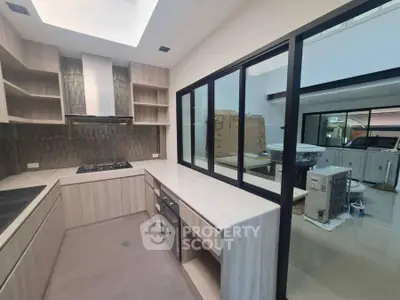 Modern kitchen with sleek cabinetry and gas stove in a contemporary home