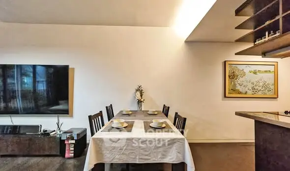 Charming dining area with elegant table setting and modern decor in cozy apartment.