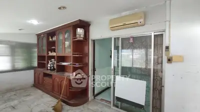 Spacious living room with built-in wooden cabinet and air conditioning