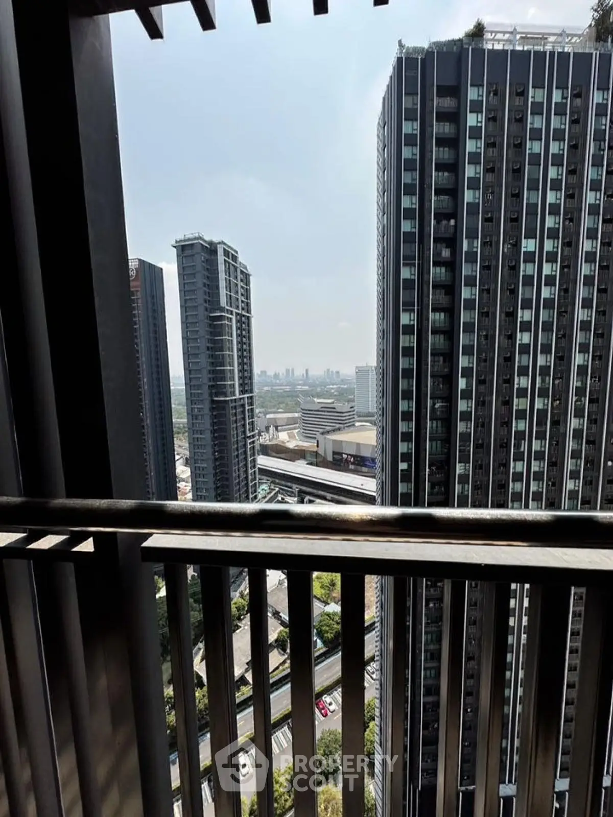 Stunning cityscape view from a high-rise balcony, showcasing modern skyscrapers and urban landscape.