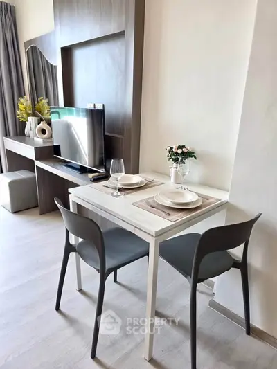 Modern living room with stylish dining area and TV setup, perfect for cozy urban living.