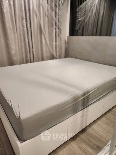 Spacious bedroom with modern bed and elegant curtains, perfect for restful nights.