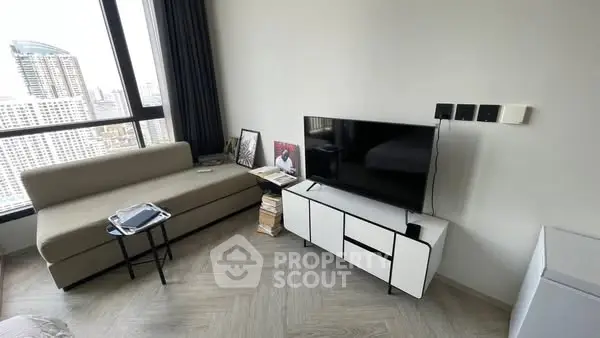 Modern living room with city view, sleek furniture, and natural light.