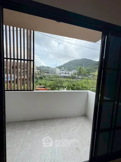 Spacious balcony with scenic mountain view, perfect for relaxation and enjoying nature.