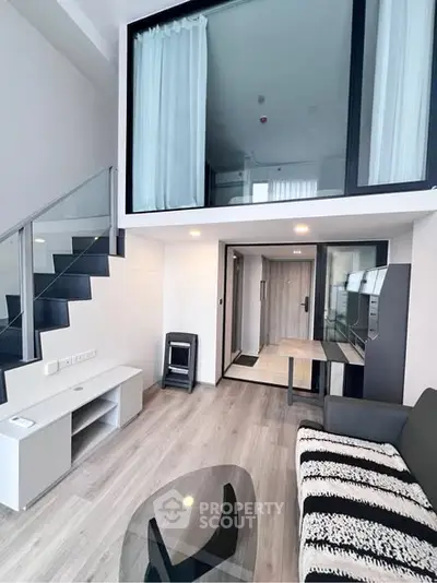 Modern duplex apartment with sleek staircase and stylish interior design.