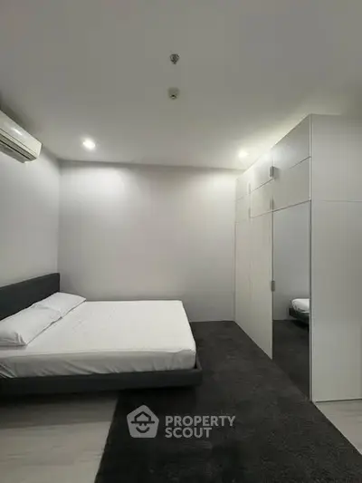 Modern minimalist bedroom with sleek design and ample storage space