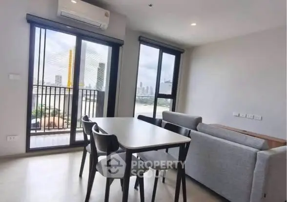 Modern living room with dining area and balcony view in a stylish apartment.
