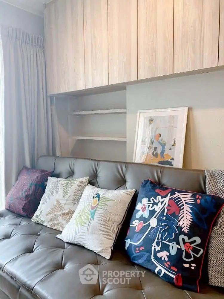 Stylish living room with modern decor and colorful cushions on a sleek sofa, perfect for cozy relaxation.