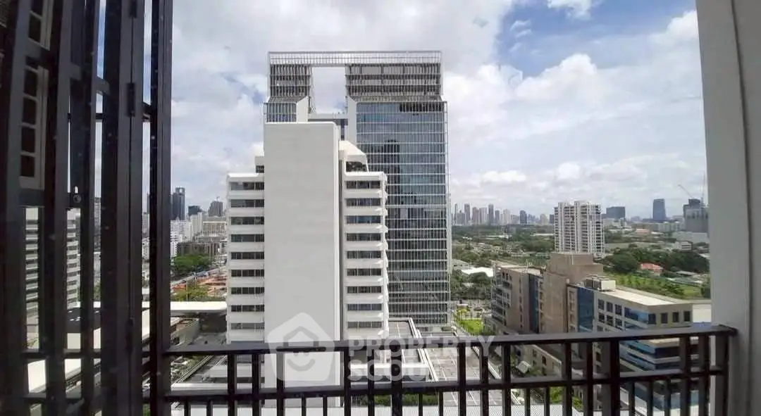 Stunning cityscape view from a high-rise balcony showcasing modern architecture and urban skyline.