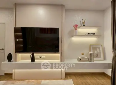 Modern living room with sleek TV setup and stylish shelving