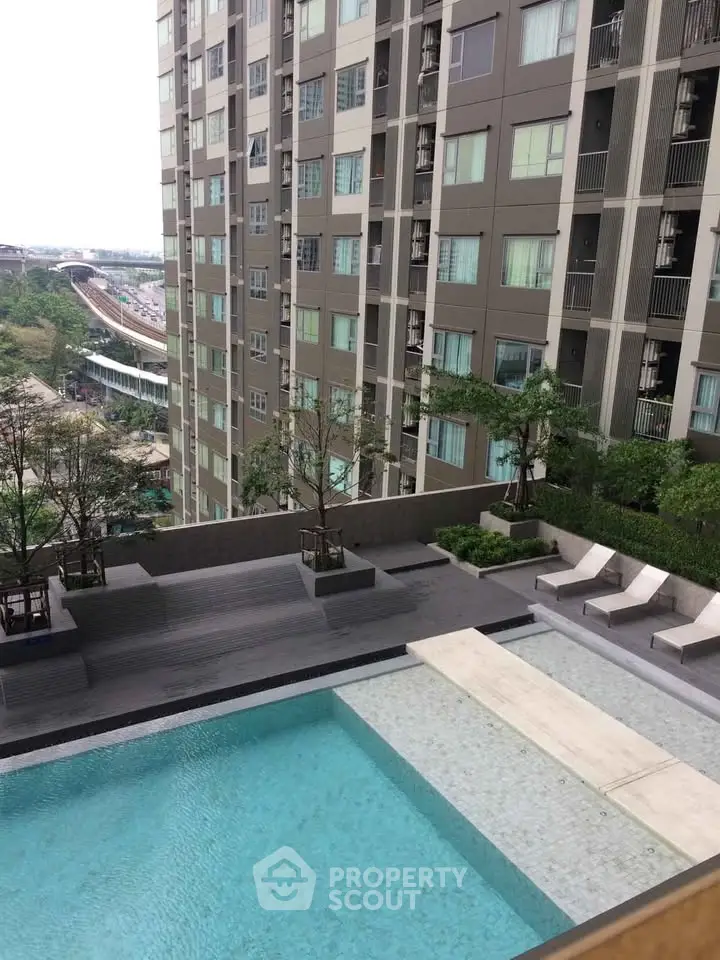 Modern apartment building with pool and city view, ideal for urban living.