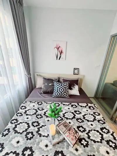Cozy bedroom with stylish decor and natural light, perfect for relaxation and comfort.