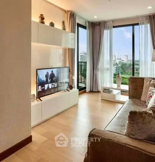 Modern living room with large windows and stylish decor, offering a cozy and inviting atmosphere.