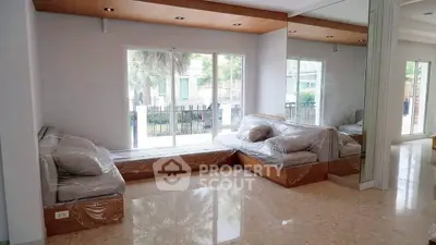 Spacious living room with large windows and modern design, perfect for natural light lovers.