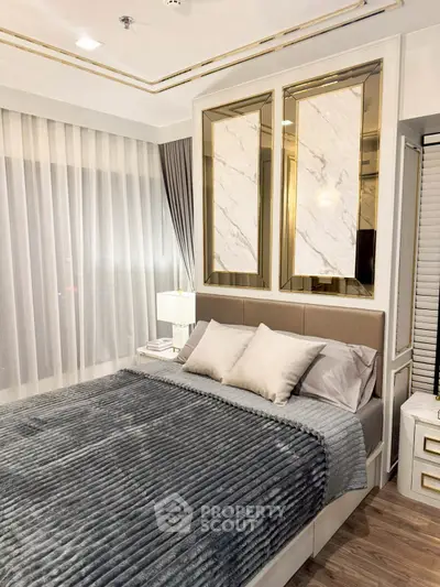 Luxurious bedroom with elegant decor and plush bedding in modern apartment.