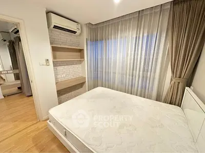 Modern bedroom with large window, air conditioning, and stylish shelving in a cozy apartment.