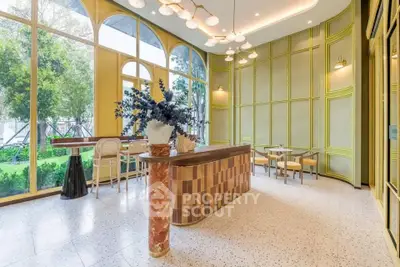 Elegant modern interior with large windows and stylish decor, perfect for a chic cafe or lounge area.