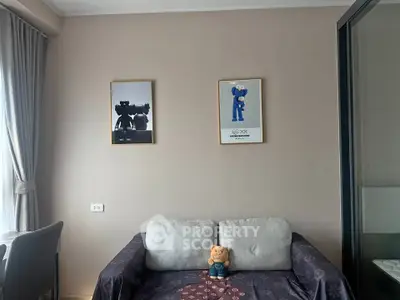 Cozy living room with plush sofa and framed art, perfect for relaxation.
