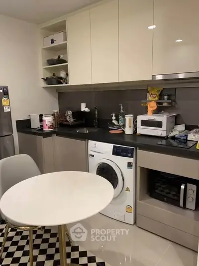 Modern kitchen with integrated washing machine and sleek appliances