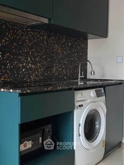 Modern kitchen with terrazzo backsplash and built-in washing machine