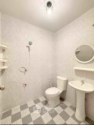 Modern minimalist bathroom with white tiles and sleek fixtures
