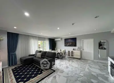 Spacious modern living room with elegant decor and marble flooring